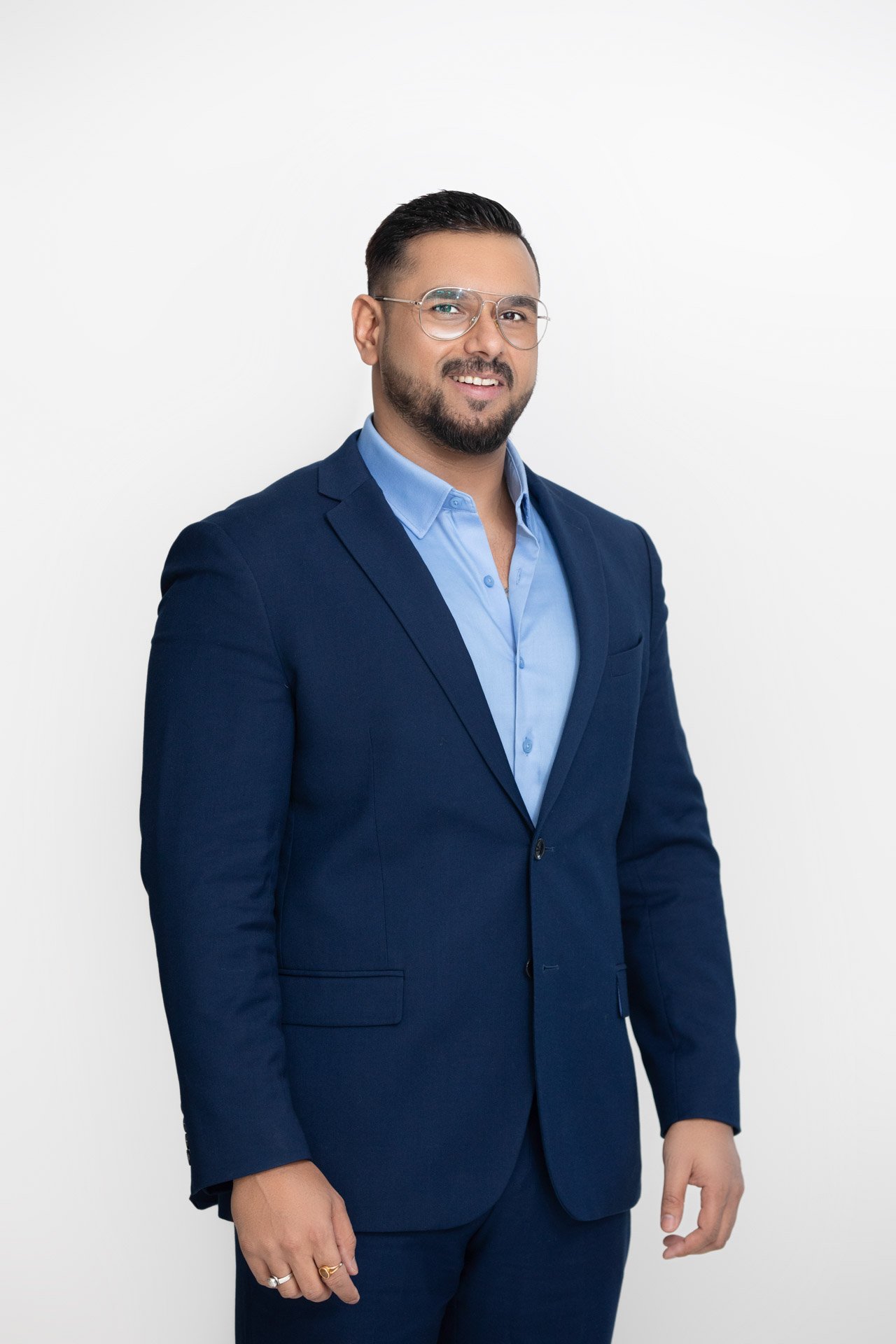 Executive headshot of a man in a navy suit